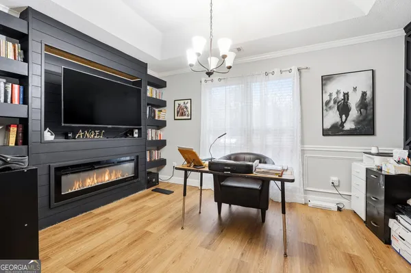 a livingroom with furniture fireplace and a flat screen tv