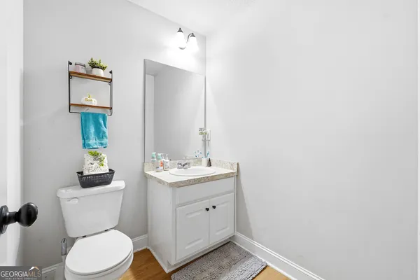 a bathroom with a toilet a sink and mirror