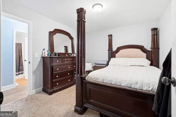 a bedroom with a bed and a dresser