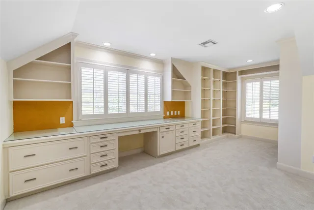 a spacious bathroom with a double vanity sink mirror and bathtub