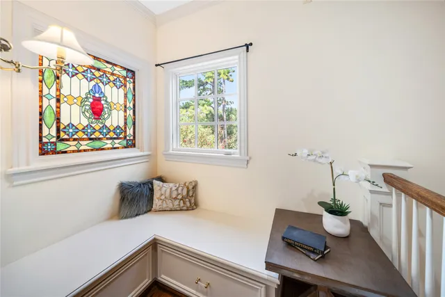 a view of a hallway with wooden floor and staircase