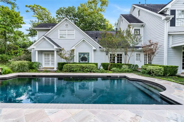 a view of a house with swimming pool and sitting area