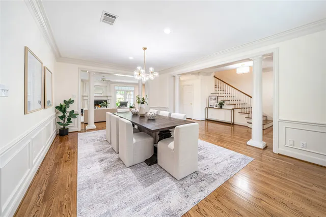a large white kitchen with sink and wooden floor