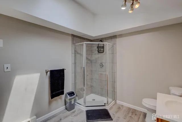 a bathroom with a toilet a sink and shower