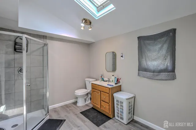 a bathroom with a toilet sink and shower