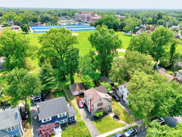 an aerial view of residential house with outdoor space and swimming pool