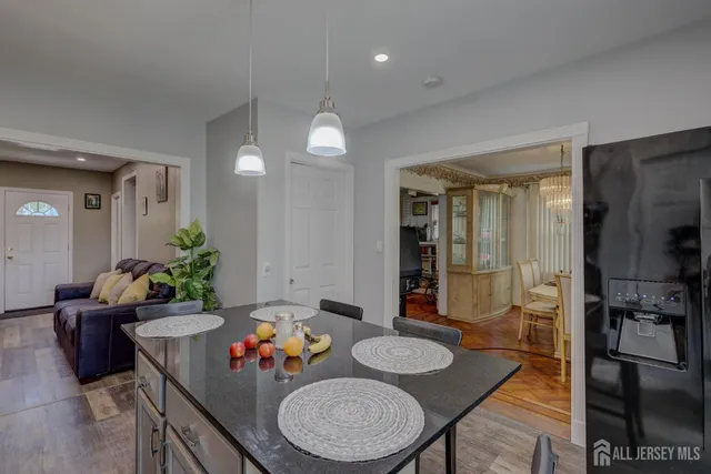 a dining room with furniture and a chandelier