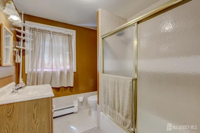 a bathroom with a granite countertop sink mirror and shower