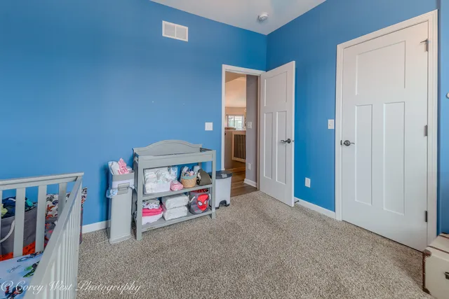 a room that has a bed and a white cabinet