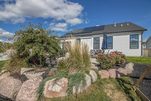 a front view of house with yard and outdoor seating