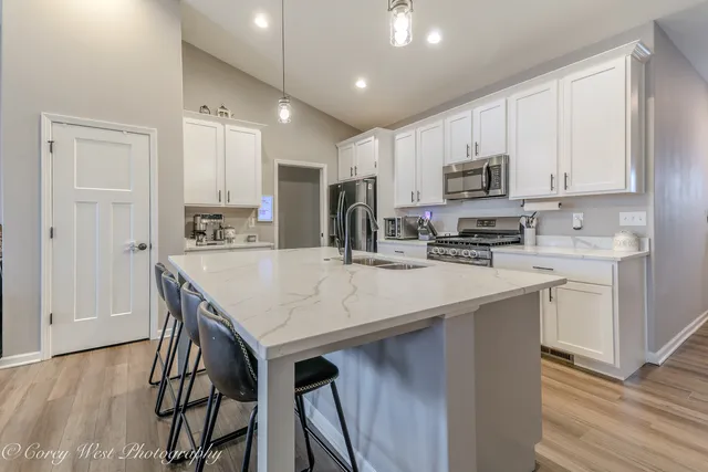 a kitchen with kitchen island appliances cabinets and furniture