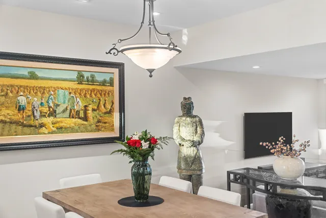 a view of dining room with furniture and flowers