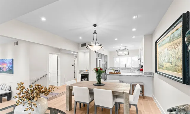 a view of a a dining room with furniture window and wooden floor