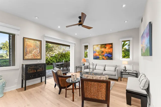 a living room with furniture a window and a flat screen tv