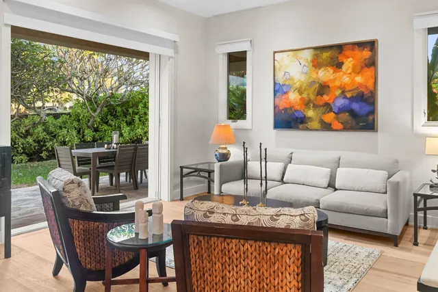 a living room with furniture a rug and a large window