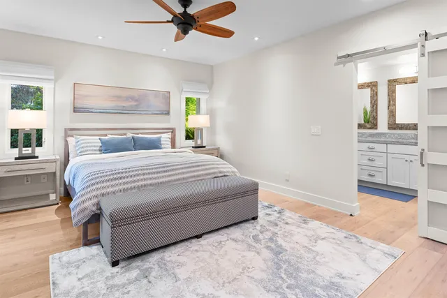 a bedroom with a bed and a view of kitchen