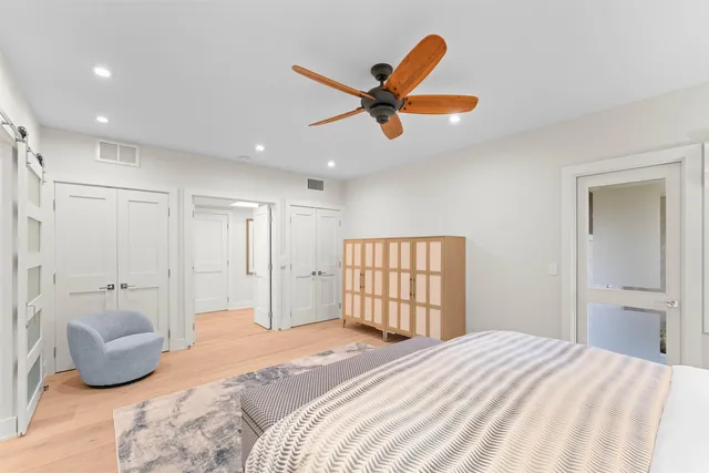 a bedroom with a bed and a large mirror