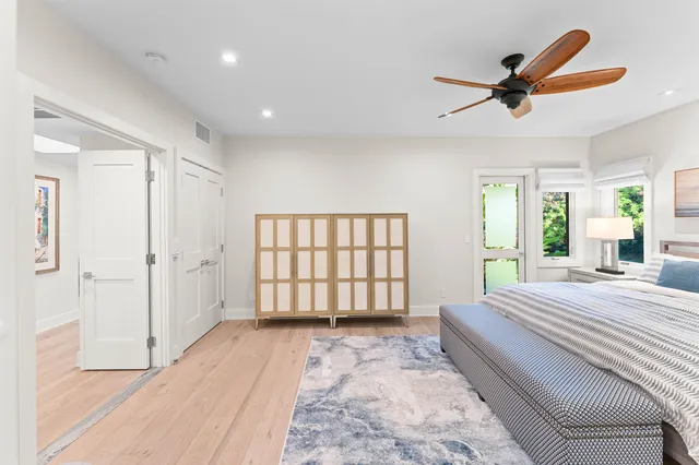 a spacious bedroom with a large bed and a chandelier