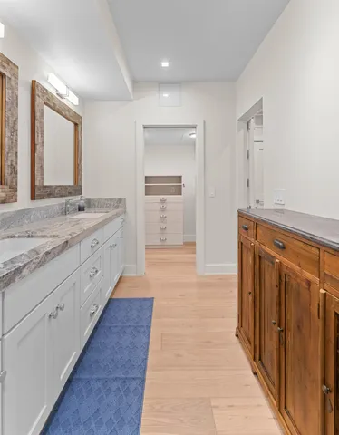 a bathroom with a granite countertop sink mirror and