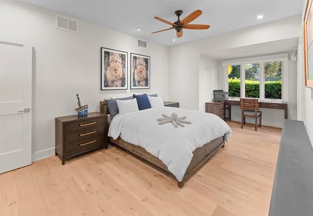 a bedroom with a large bed and a chandelier