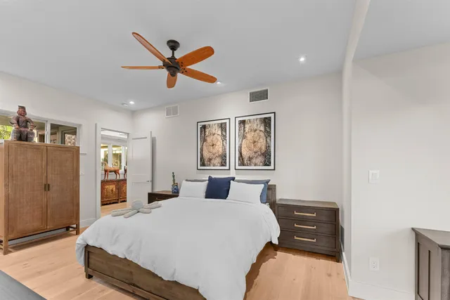 a bathroom with a granite countertop sink a toilet and shower