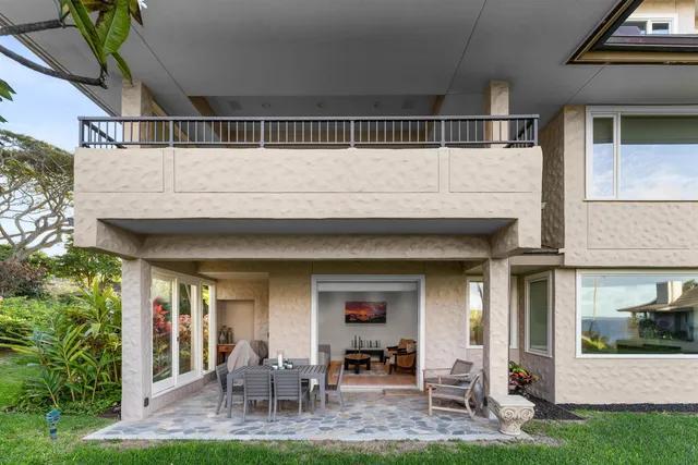 front view of a house with a yard and potted plants