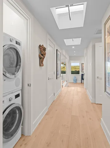 a view of a hallway with washer and dryer