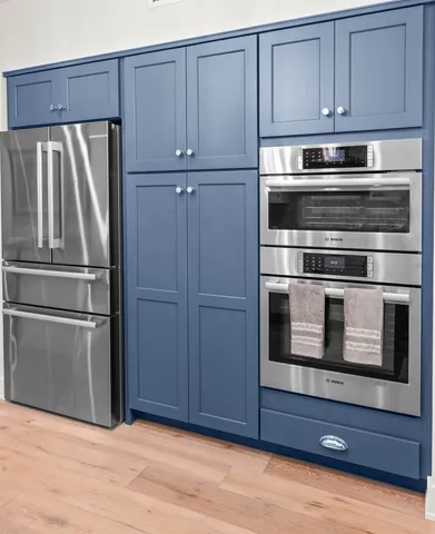 a kitchen with cabinets and stainless steel appliances
