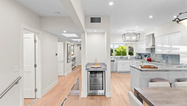 a kitchen with stainless steel appliances a stove and more cabinets