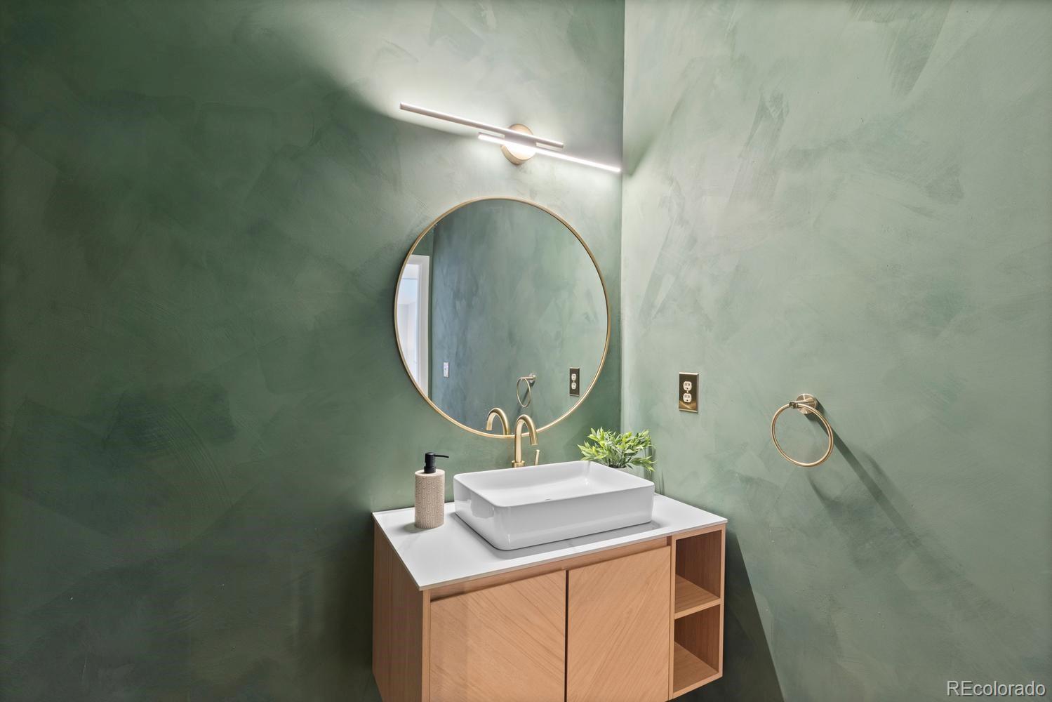 3900 Pierson Street Wheat Ridge, CO 80033 - Photo 18 of 39 a bathroom with a sink and mirror