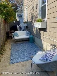 a view of a patio with a table and chairs