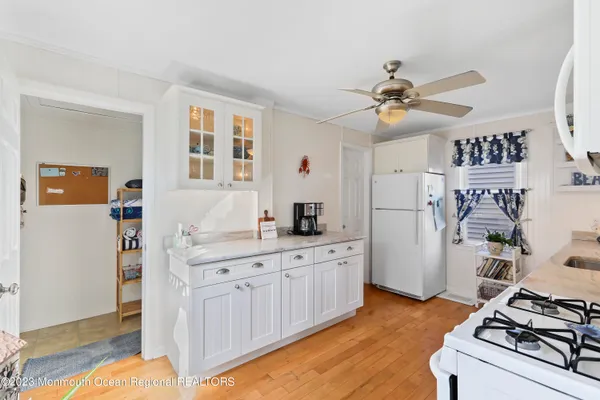 a kitchen with a sink appliances and cabinets