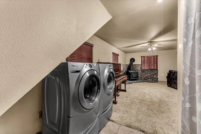 a spacious bedroom with a bed and a flat screen tv