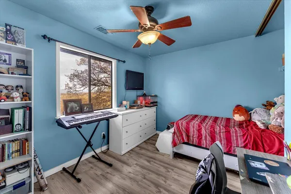 a bedroom with a bed and a chandelier