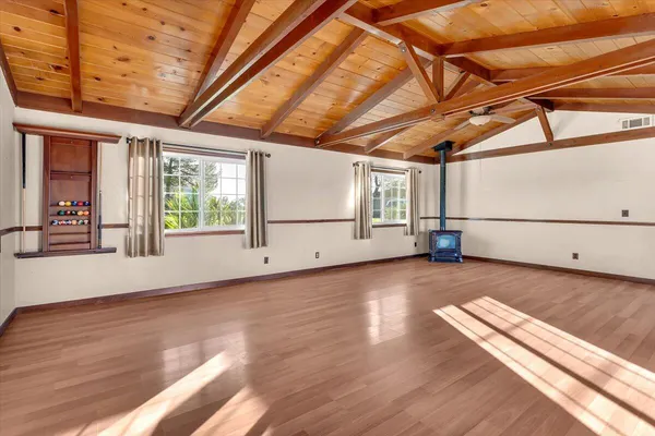 a view of a room with wooden floors and windows
