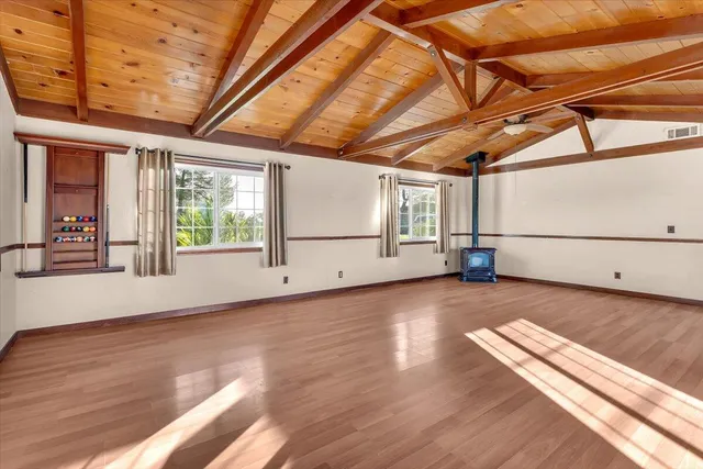 a view of a room with wooden floors and windows