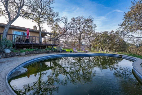 a swimming pool with outdoor seating and yard
