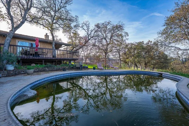 a swimming pool with outdoor seating and yard