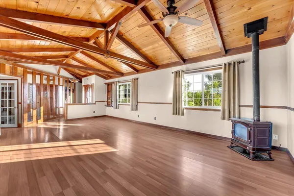 a view of a livingroom with wooden floor and furniture