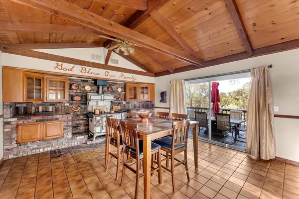 a kitchen with stainless steel appliances granite countertop a sink a stove and cabinets