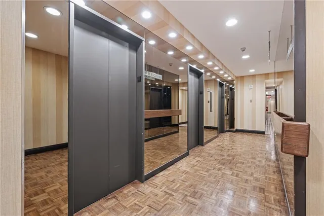 a view of hallway with stainless steel appliances kitchen island granite countertop furniture