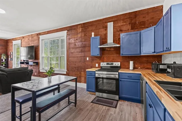 a kitchen with a stove a sink and cabinets