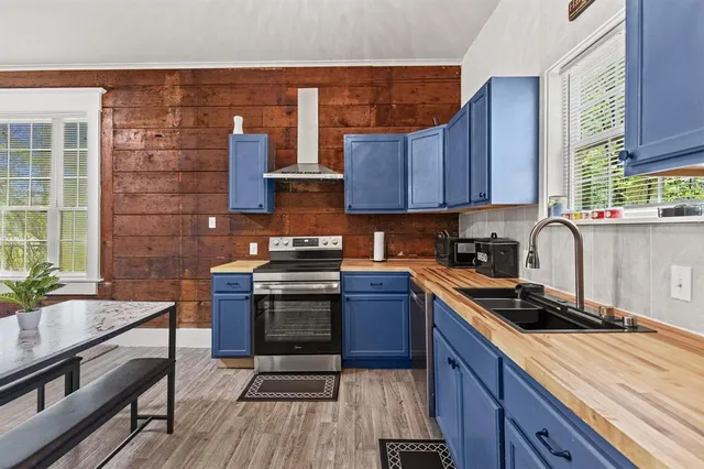 a kitchen with a sink stove and cabinets