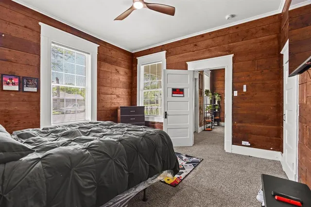 a bed sitting in front of a bedroom next to a window