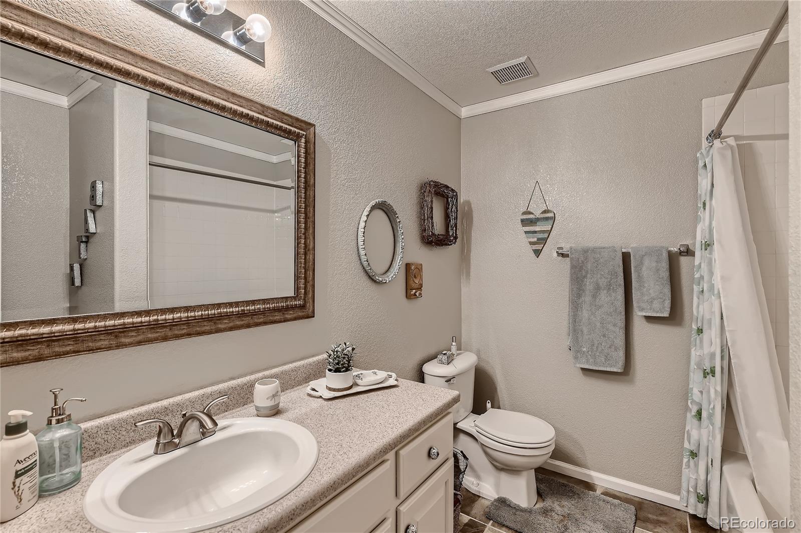 166 Whitehaven Circle Highlands Ranch, CO 80129 - Photo 14 of 28 a bathroom with a granite countertop sink toilet and shower