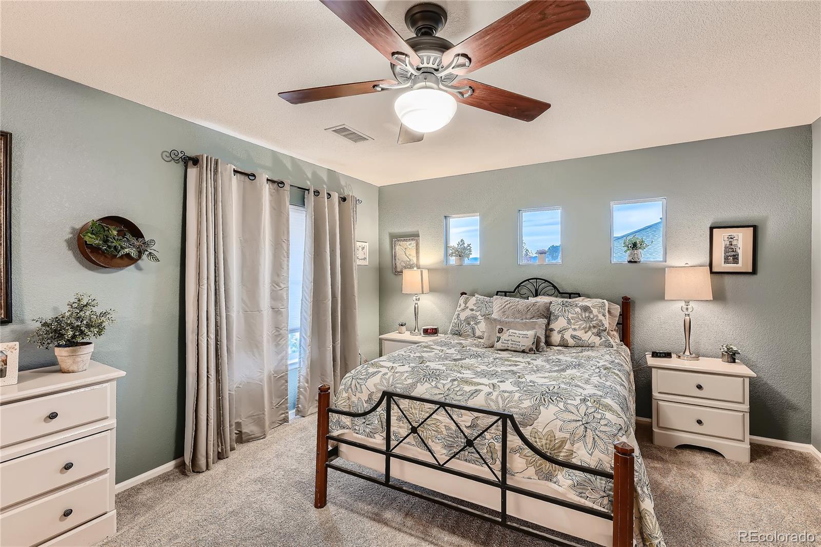 166 Whitehaven Circle Highlands Ranch, CO 80129 - Photo 15 of 28 a bed room with a bed and a chandelier