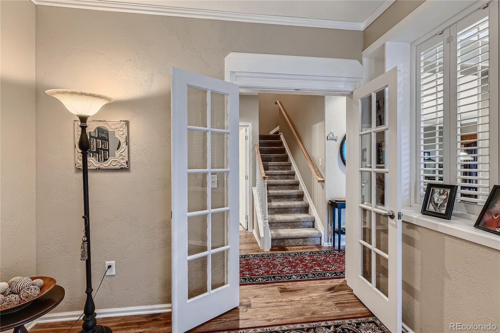 166 Whitehaven Circle Highlands Ranch, CO 80129 - Photo 24 of 28 a view of entryway with furniture and wooden floor
