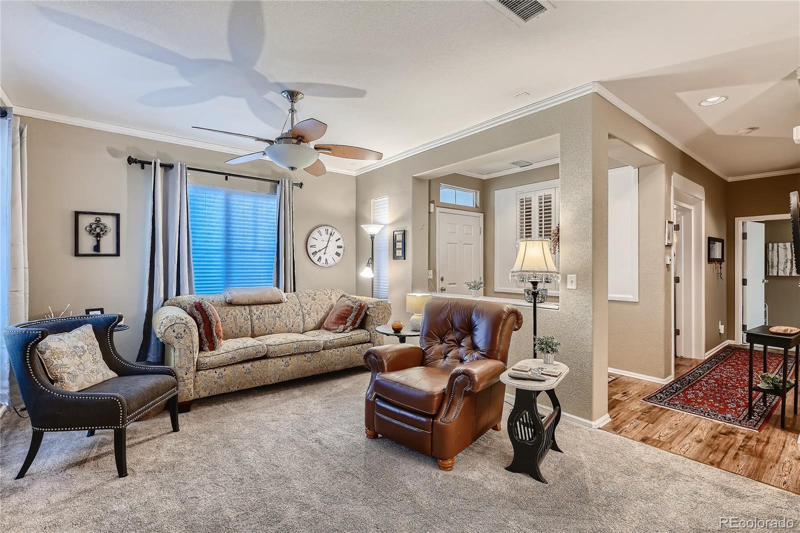 166 Whitehaven Circle Highlands Ranch, CO 80129 - Photo 5 of 28 a living room with furniture and a chandelier