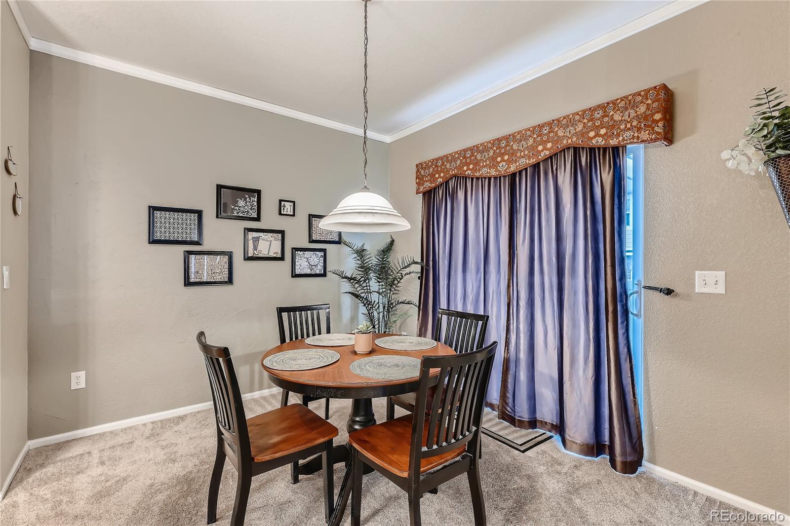 166 Whitehaven Circle Highlands Ranch, CO 80129 - Photo 9 of 28 a view of a dining room with furniture and wooden floor