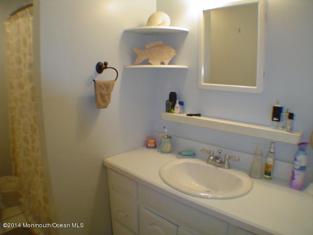 240 Crows Nest Road Manahawkin, NJ 08050 - Photo 13 of 26 a bathroom with a sink and a mirror